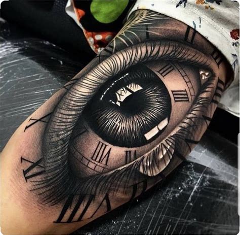 Intricate Eye and Clock Arm Tattoo Design in Wuppertal .